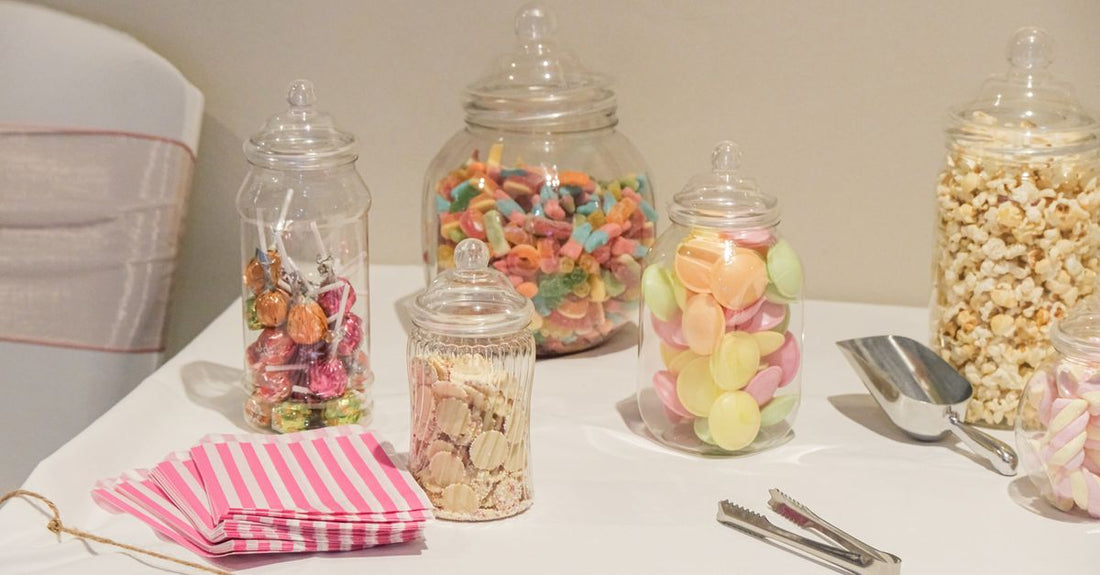 Bunte Vitamin-Gummibärchen in einem Glas auf einem hellen Holztisch – Kinder-Vitamine Kaufberatung 2026