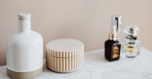 Best Lotionen 2026: Drei hochwertige Lotion-Flaschen auf einer Marmorplatte, die Feuchtigkeitspflege und Sommerschutz symbolisieren.