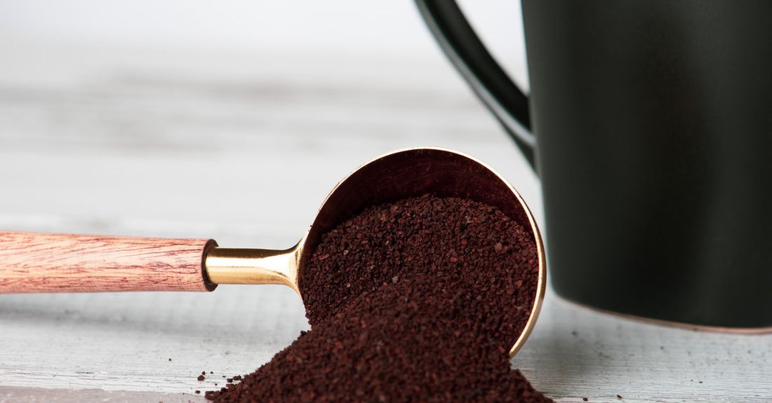 BCAA vs EAA – ein Messlöffel mit Aminosäure-Pulver neben einem Supplement-Behälter auf einer Sportmatte.