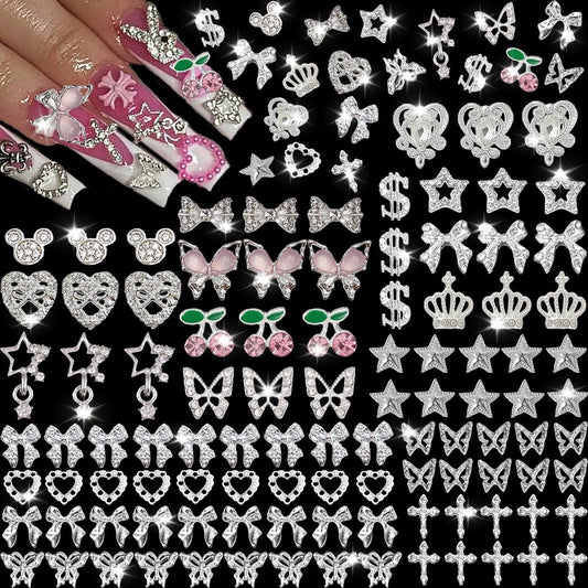 KACHIMOO 106-teilige Nagelverzierungen und -steine in Silber – 3D-Schmetterlinge, Schleifen, Sterne, Kirschen, Kreuze, Dollar, Herzen für Acrylnägel (19 Stile)